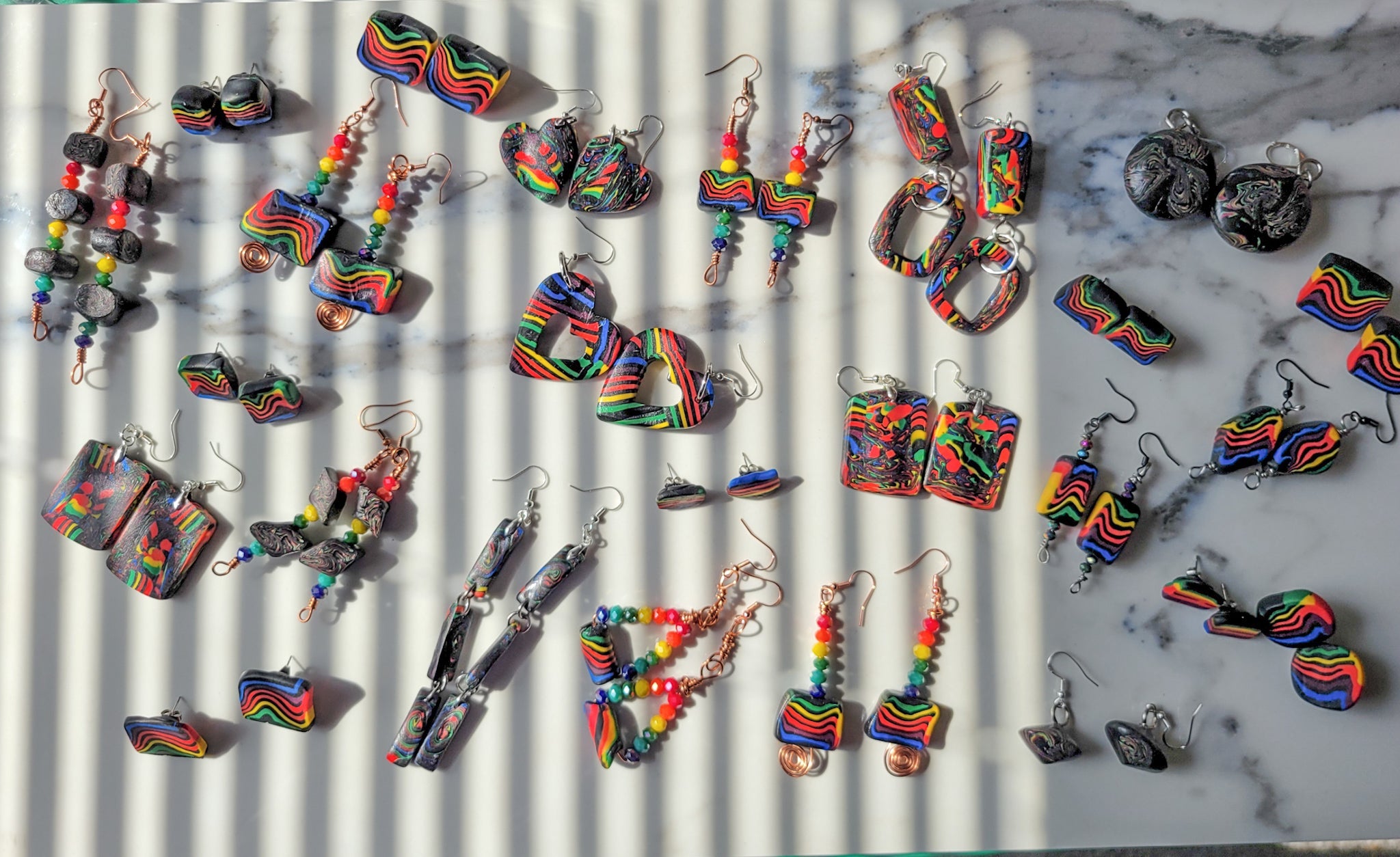 many sets of rainbow earrings